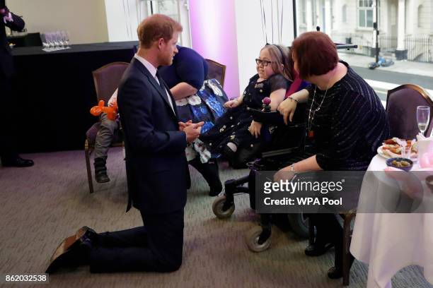 Patron of WellChild Prince Harry meets Katie Ward, aged 10, the winner of the Inspirational Child Award aged 7-10, with her mother Ruth during a...
