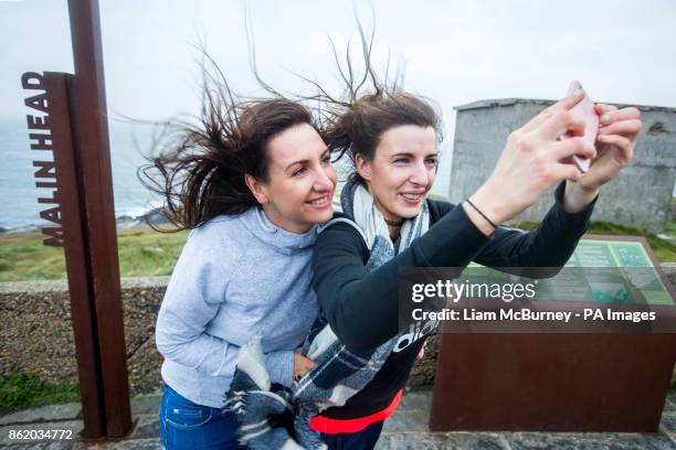 Two Donegal locals take a selfie at Banba's Crown, Malin Head. Co.Donegal, Ireland, as Hurricane Ophelia hits the UK and Ireland with gusts of up to...