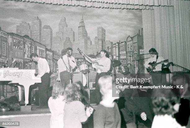 Photo of guest pianist Roy Young performing with singer-guitarist John Lennon, drummer Pete Best, singer-bassist Paul McCartney and guitarist George...
