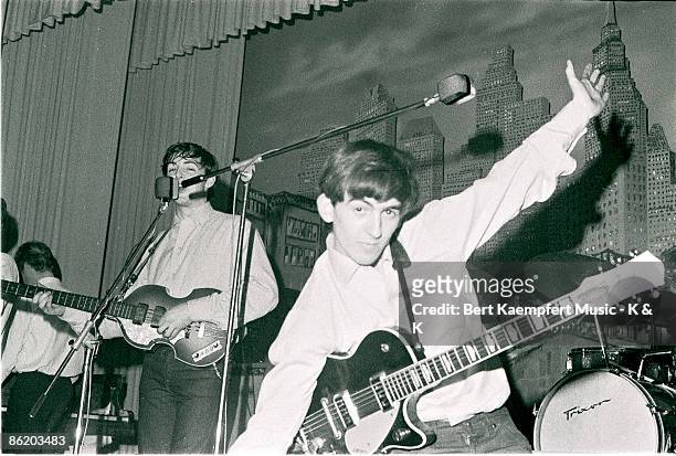 Photo of singer-bassist Paul McCartney and guitarist George Harrison of The Beatles, live onstage circa May 1962 at the Star-Club in Hamburg, Germany.