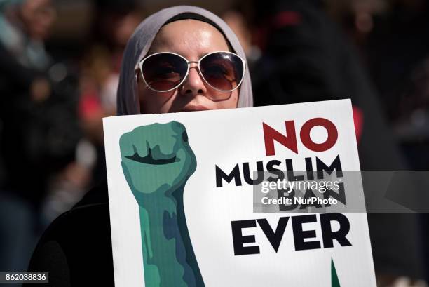 An activist holds a sign during a protest against President Trump's travel ban in Los Angeles, California on October 15, 2017. The No Muslim Ban Ever...