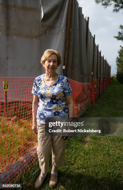Alice Aznavourian stands next to a sound curtain that surrounds a horizontal drilling operation for a Williams Transco gas pipeline near her...