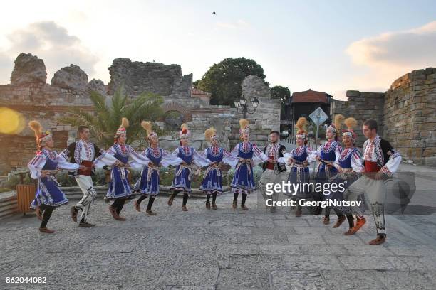 a folk dance group poses for pictures in traditional costumes. - medieval shoes stock pictures, royalty-free photos & images