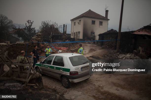Police secure the entrance to a house where allegedly three people died in the village of Vila Nova, near Vouzela on October 16, 2017 in Viseu...