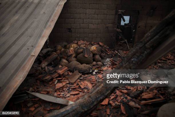 Pumpkins lay on the ground inside a burnt house in the village of Vila Nova, near Vouzela on October 16, 2017 in Viseu region, Portugal. At least 30...