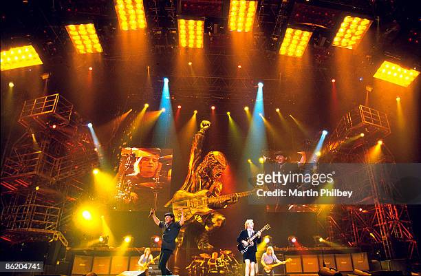 Photo of AC/DC, L-R: Malcolm Young, Brian Johnson, Phil Rudd, Angus Young, Cliff Williams performing live onstage
