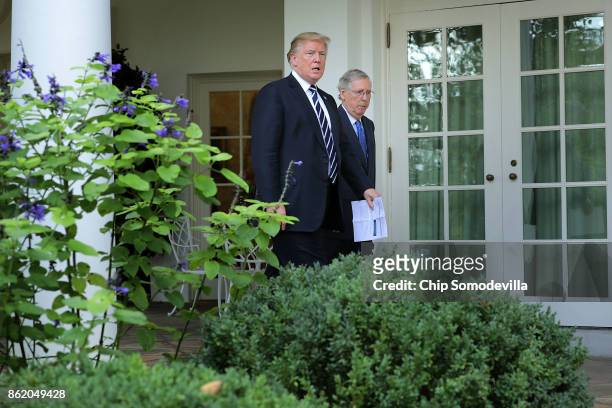 President Donald Trump and Senate Majority Leader Mitch McConnell walk into the Rose Garden to talk to reporters following a lunch meeting at the...