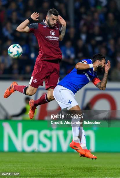 Mikael Ishak of Nuernberg challenges Aytac Sulu of Darmstadt during the Second Bundesliga match between SV Darmstadt 98 and 1. FC Nuernberg at...