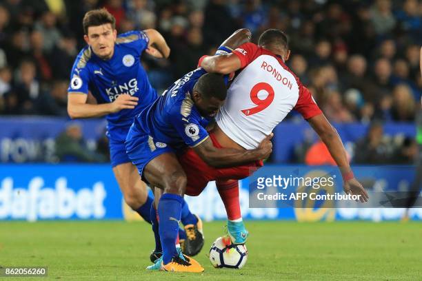 West Bromwich Albion's Venezuelan striker Salomon Rondon vies with Leicester City's English-born Jamaican defender Wes Morgan during the English...