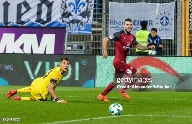 Mikael Ishak of Nuernberg scores the second goal for his team against Joel Mall of Darmstadt during the Second Bundesliga match between SV Darmstadt...