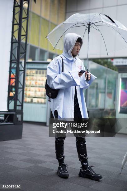 Guest is seen attending YOHEI OHNO and DRESSEDUNDRESSED during Tokyo Fashion Week wearing a blue shirt with black rayon pants on October 16, 2017 in...