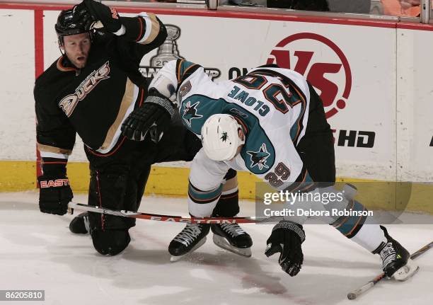 Ryane Clowe of the San Jose Sharks gets tripped up with Ryan Whitney of the Anaheim Ducks during Game Four of the Western Conference Quarterfinal...