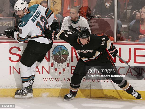 Patrick Marleau of the San Jose Sharks is shoved into the wall by Sheldon Brookbank of the Anaheim Ducks during Game Four of the Western Conference...
