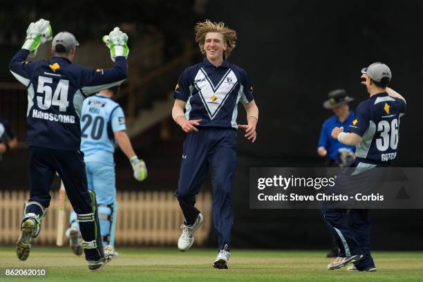 Will Sutherland of Victoria celebrates taking the wicket of Mitchell Starc of NSW during the JLT One Day Cup match between New South Wales and...