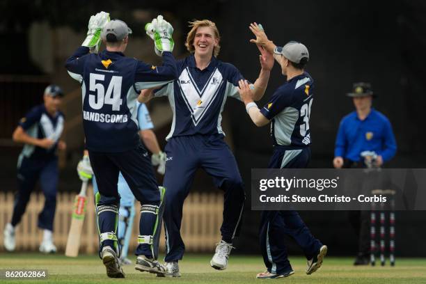 Will Sutherland of Victoria celebrates taking the wicket of Mitchell Starc of NSW during the JLT One Day Cup match between New South Wales and...