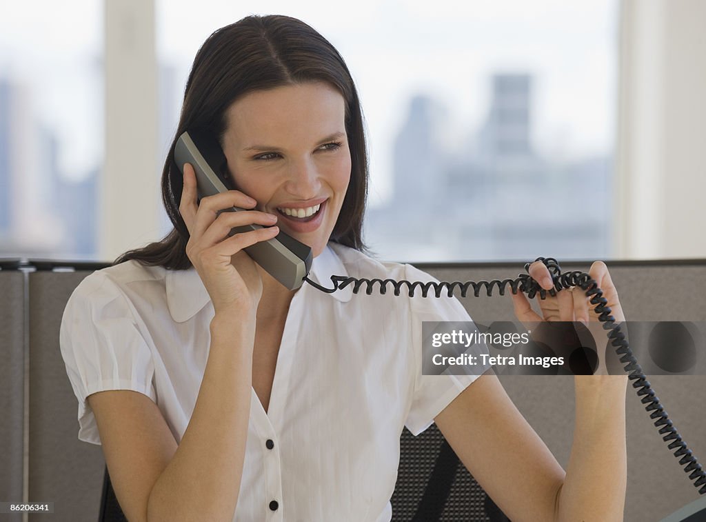 Businesswoman talking on telephone