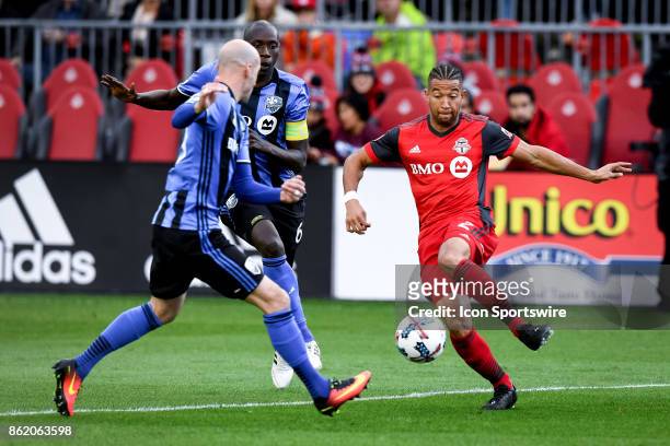 Justin Morrow of Toronto FC dribbles past Hassoun Camara of Montreal Impact during the first half of the MLS Soccer regular season game between...