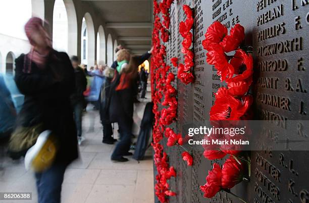 Poppies are placed beside the names of those who lost their lives on the Roll of Honour for World War II during the ANZAC dawn service at the...