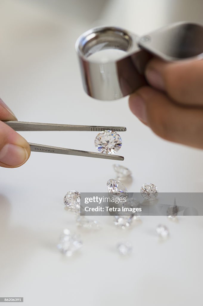 Gemologist inspecting diamonds using loupe