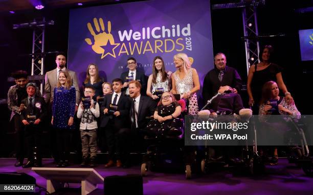 Patron of WellChild, Prince Harry poses for a group photograph with the winners on stage at the annual WellChild awards at the Royal Lancaster Hotel...