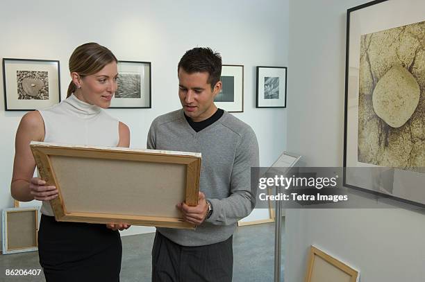 curators examining painting in art gallery - museumswärter stock-fotos und bilder