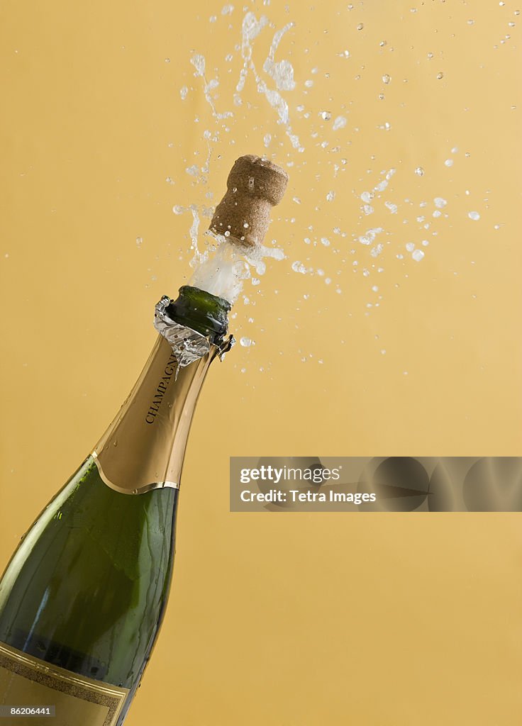 Cork Exploding From Champagne Bottle Photo - Getty Images