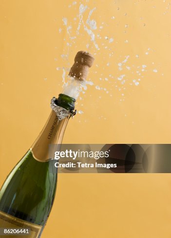Cork exploding from champagne bottle Cork exploding from champagne bottle