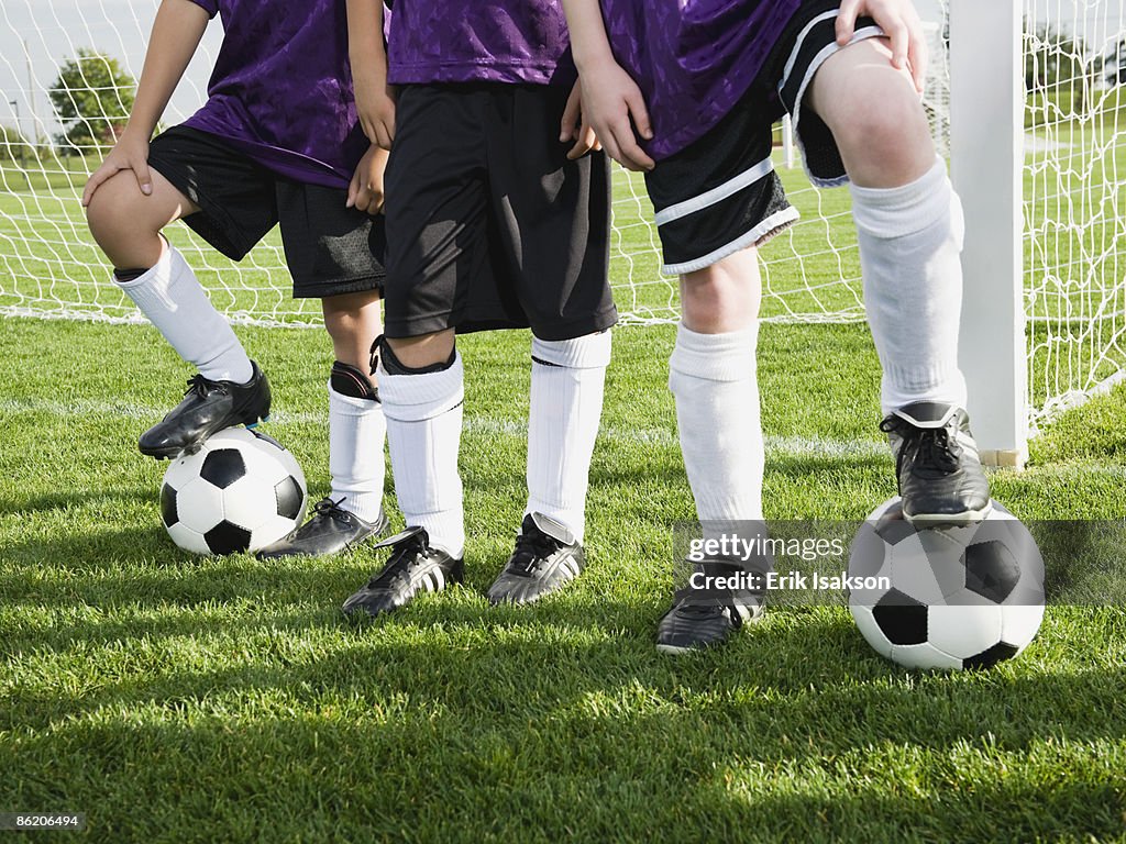 Boys standing near goal on soccer field