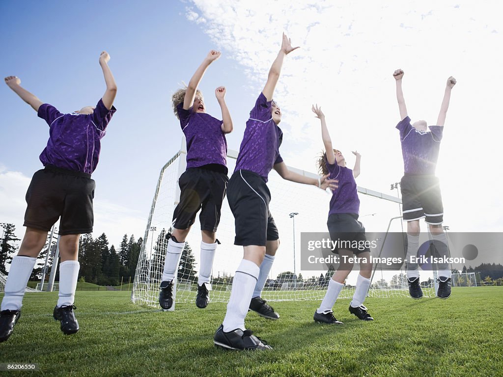 Boys soccer team celebrating on field