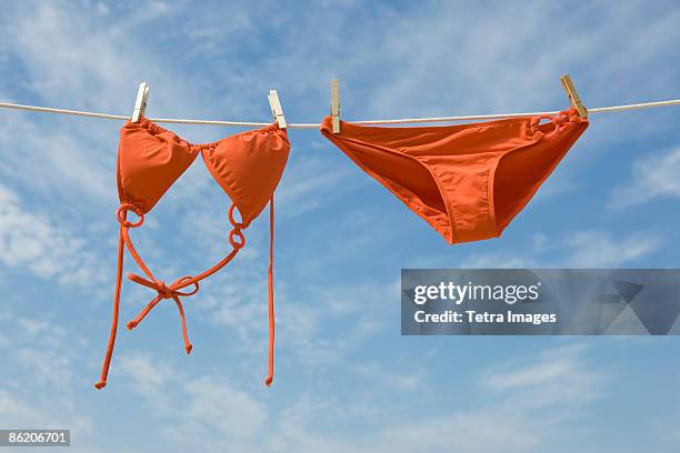 bikini hanging from clothesline - swimsuit stockfoto's en -beelden