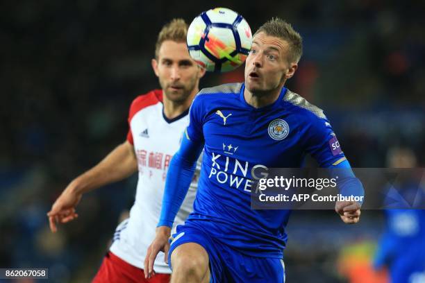 West Bromwich Albion's English defender Craig Dawson vies with Leicester City's English striker Jamie Vardy during the English Premier League...