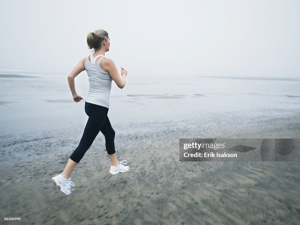 Woman jogging on beach