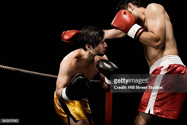 boxers fighting in boxing ring - ducking stock pictures, royalty-free photos & images