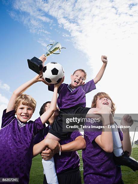 boys soccer team celebrating with trophy - champions day four stock pictures, royalty-free photos & images