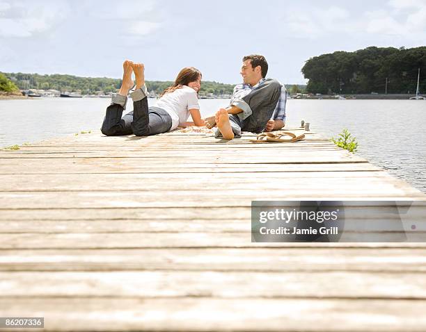couple laying on dock - huntington suffolk county new york state stock-fotos und bilder