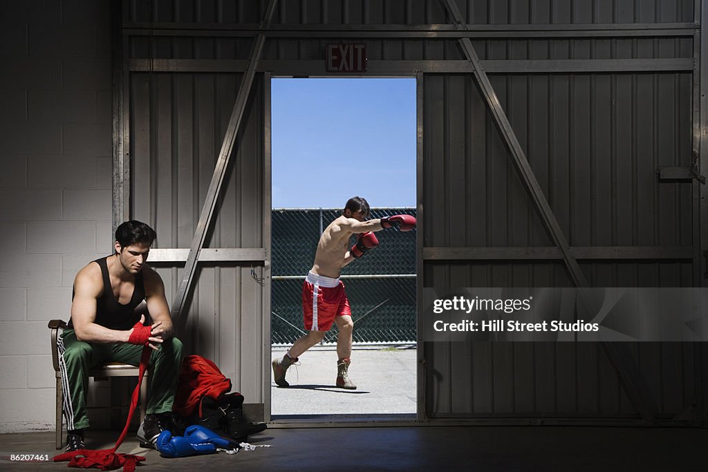 Boxers wrapping hands and practicing