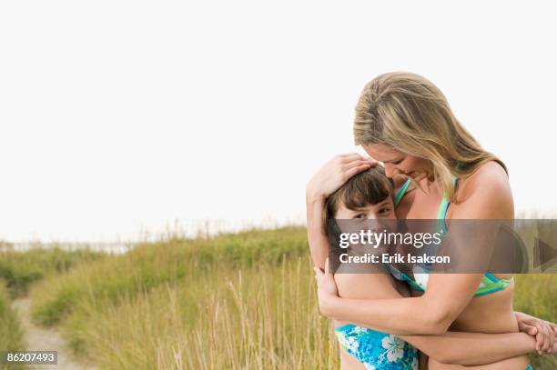 portrait of mother hugging daughter on beach - lincoln city oregon stock pictures, royalty-free photos & images