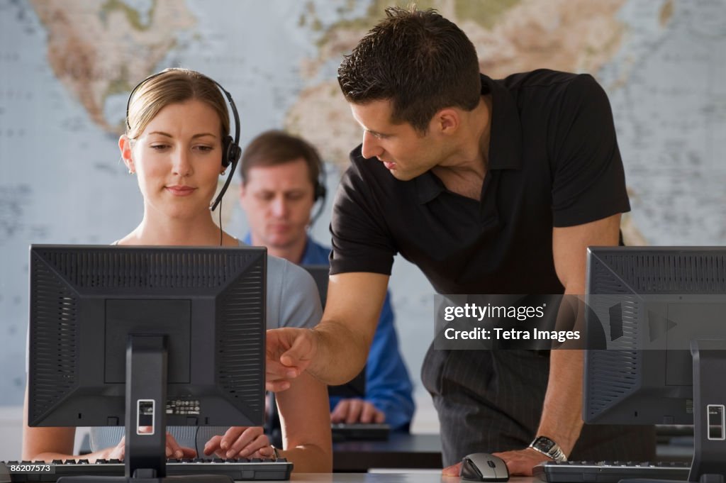 Businessman training call center employee
