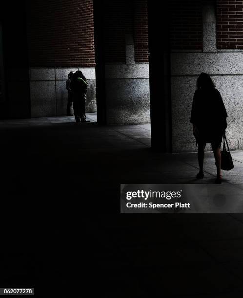 People walk through lower Manhattan on October 16, 2017 in New York City. The U.S. Department of Justice has claimed that New York City is violating...