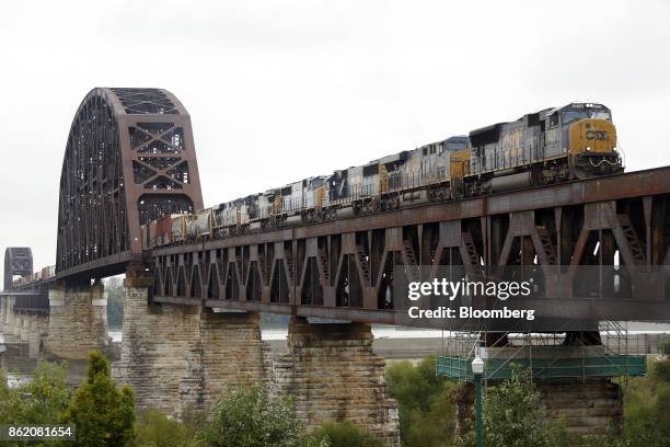 Corp. Freight train crosses a bridge over the Ohio River into Clarksville, Indiana, U.S., on Thursday, Oct. 12, 2017. CSX is scheduled to release...