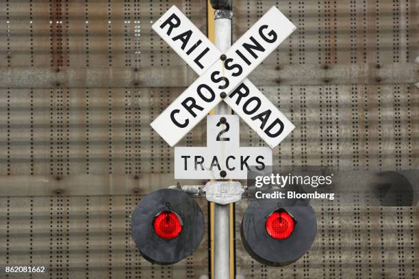 Railroad crossing gate stands along tracks owned by CSX Corp. In Bowling Green, Kentucky, U.S., on Thursday, Oct. 12, 2017. CSX is scheduled to...