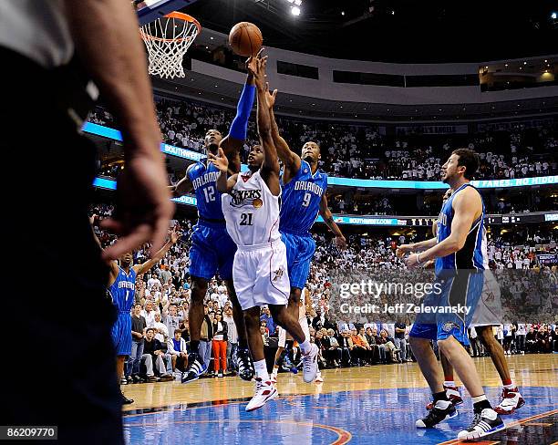 Thaddeus Young of the Philadelphia 76ers puts up the game-winning shot between Dwight Howard and Rashard Lewis the Orlando Magic during Game Three of...