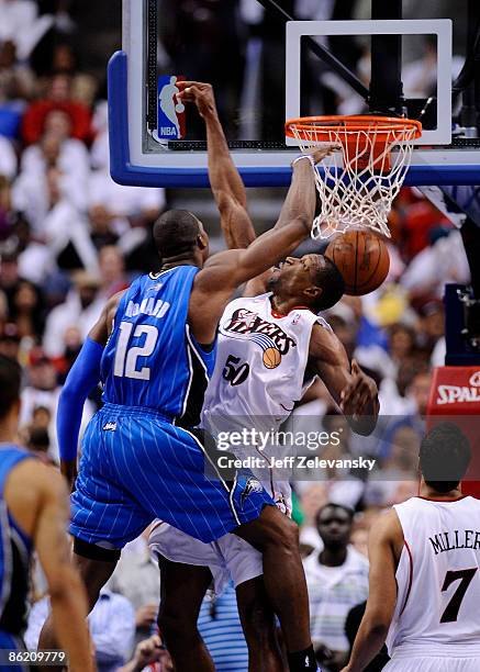 Dwight Howard of the Orlando Magic dunks dunks against Theo Ratliff of the Philadelphia 76ers of the Orlando Magic during Game Three of the Eastern...