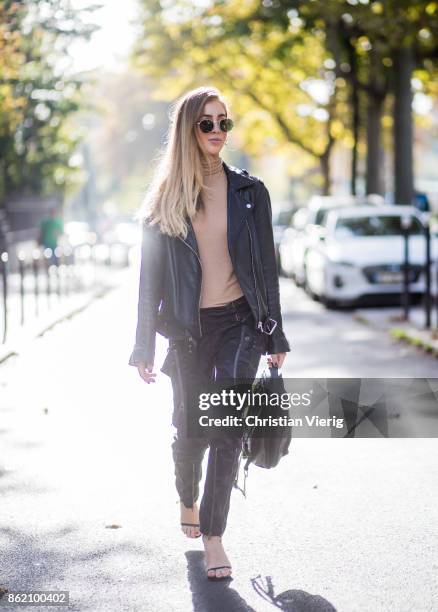 Fashion Blogger Rosa Crespo wearing Faith Connexion pants, heels Saint Laurent, black All Saints leather jacket, beige turtleneck, black Nat & Nin...