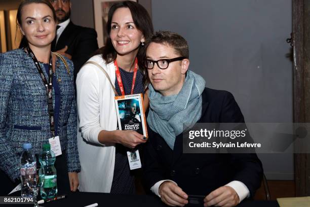 Director Nicolas Winding Refn poses with fans as he signs his book during 9th Film Festival Lumiere on October 16, 2017 in Lyon, France.