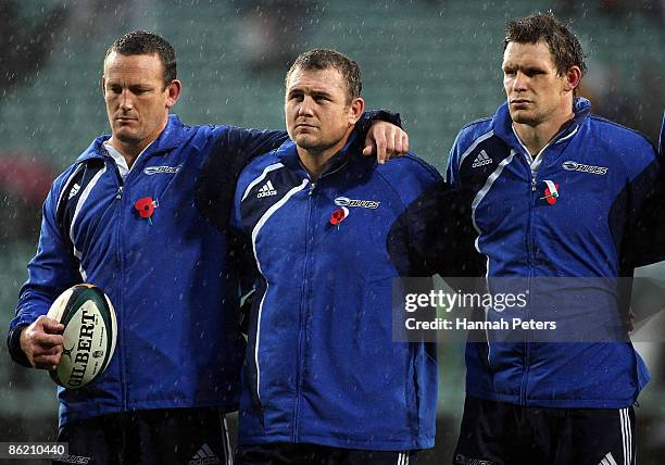 Justin Collins, Tony Woodcock and Josh Blackie of the Blues stand together as "The Last Post" is played in remembrance of ANZAC Day prior to the...