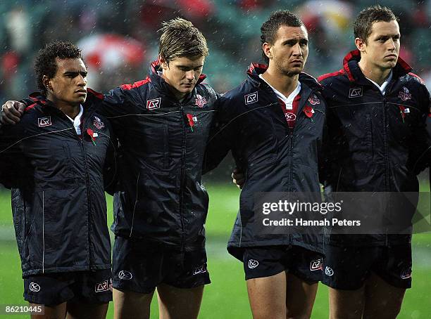 Members of the Reds team stand together as "The Last Post" is played in remembrance of ANZAC Day prior to the round 11 Super 14 match between the...