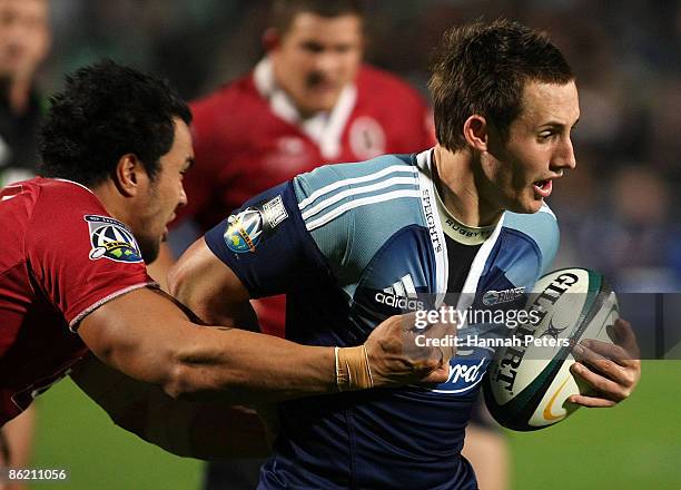 Michael Hobbs of the Blues is tackled during the round 11 Super 14 match between the Blues and the Reds at North Harbour Stadium on April 25, 2009 in...