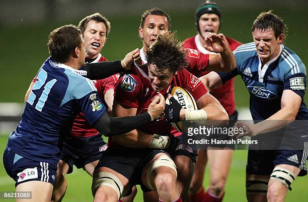 Hugh McMeniman of the Reds tries to get away from Jimmy Gopperth of the Blues during the round 11 Super 14 match between the Blues and the Reds at...