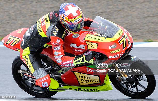 Swiss 125cc rider Dominique Aegerter speeds his Derbi during the free practice session in the MotoGP Japanese Grand Prix at Twin Ring Motegi circuit...